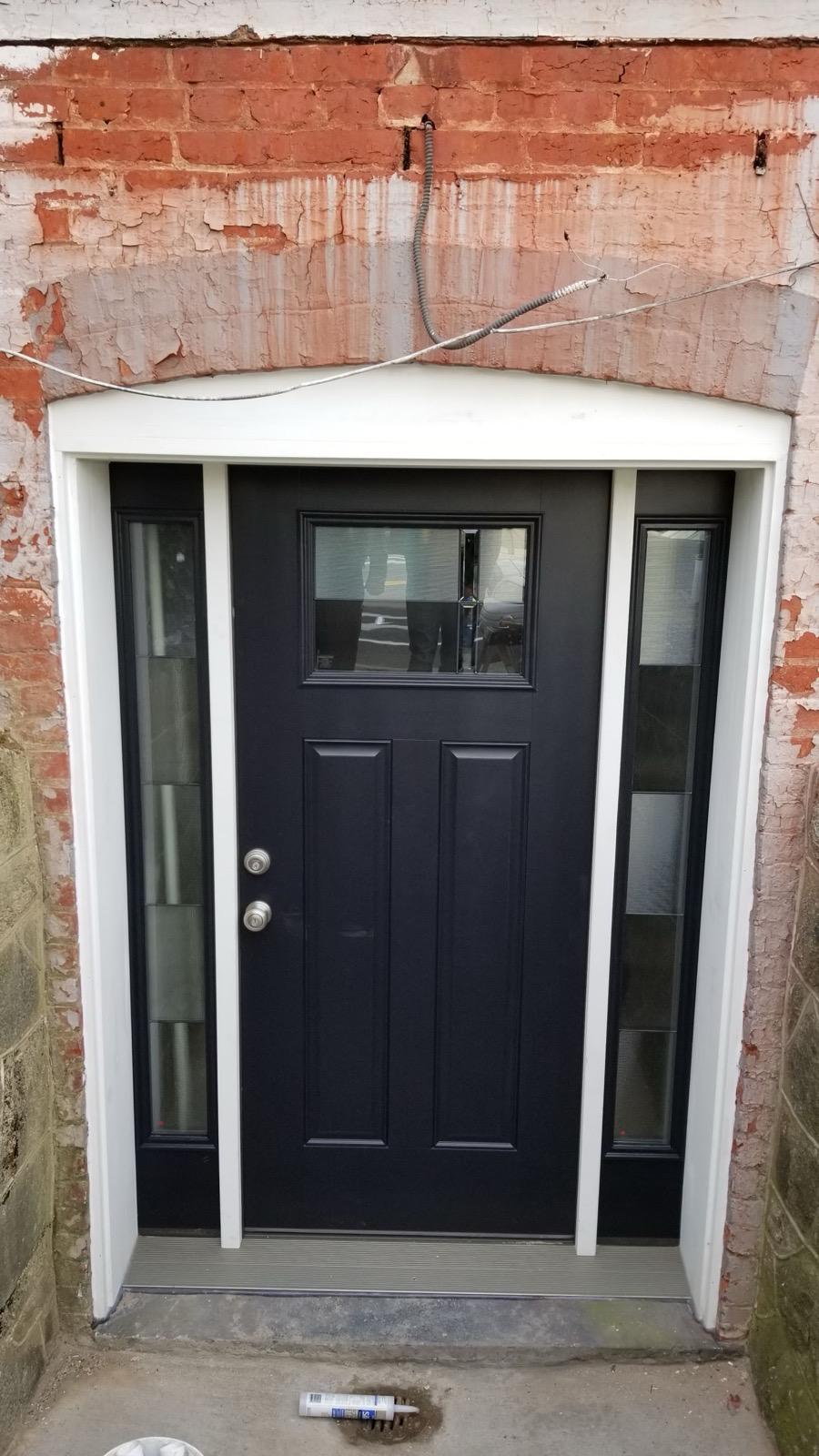 After — black craftsman door installed
