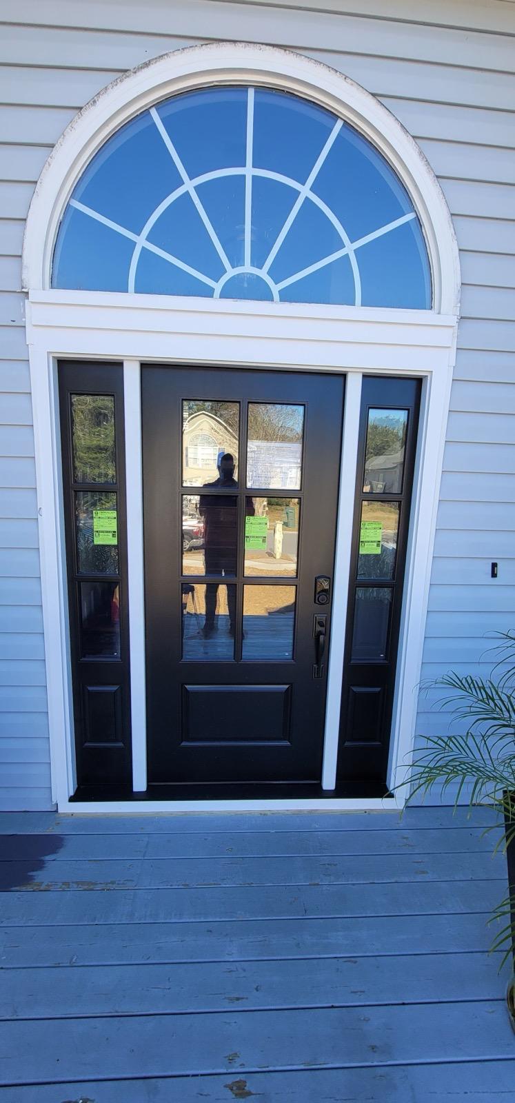 Black door with sidelights and arched transom