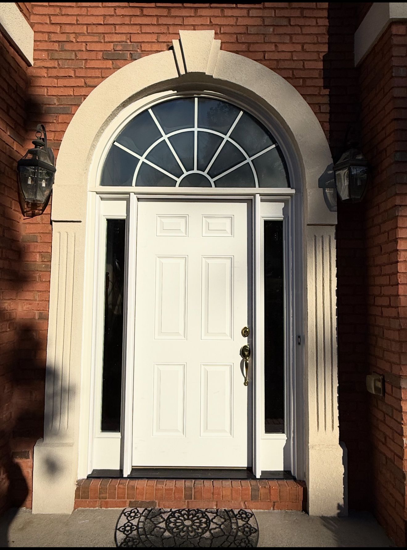 Classic white door with arch and sidelights