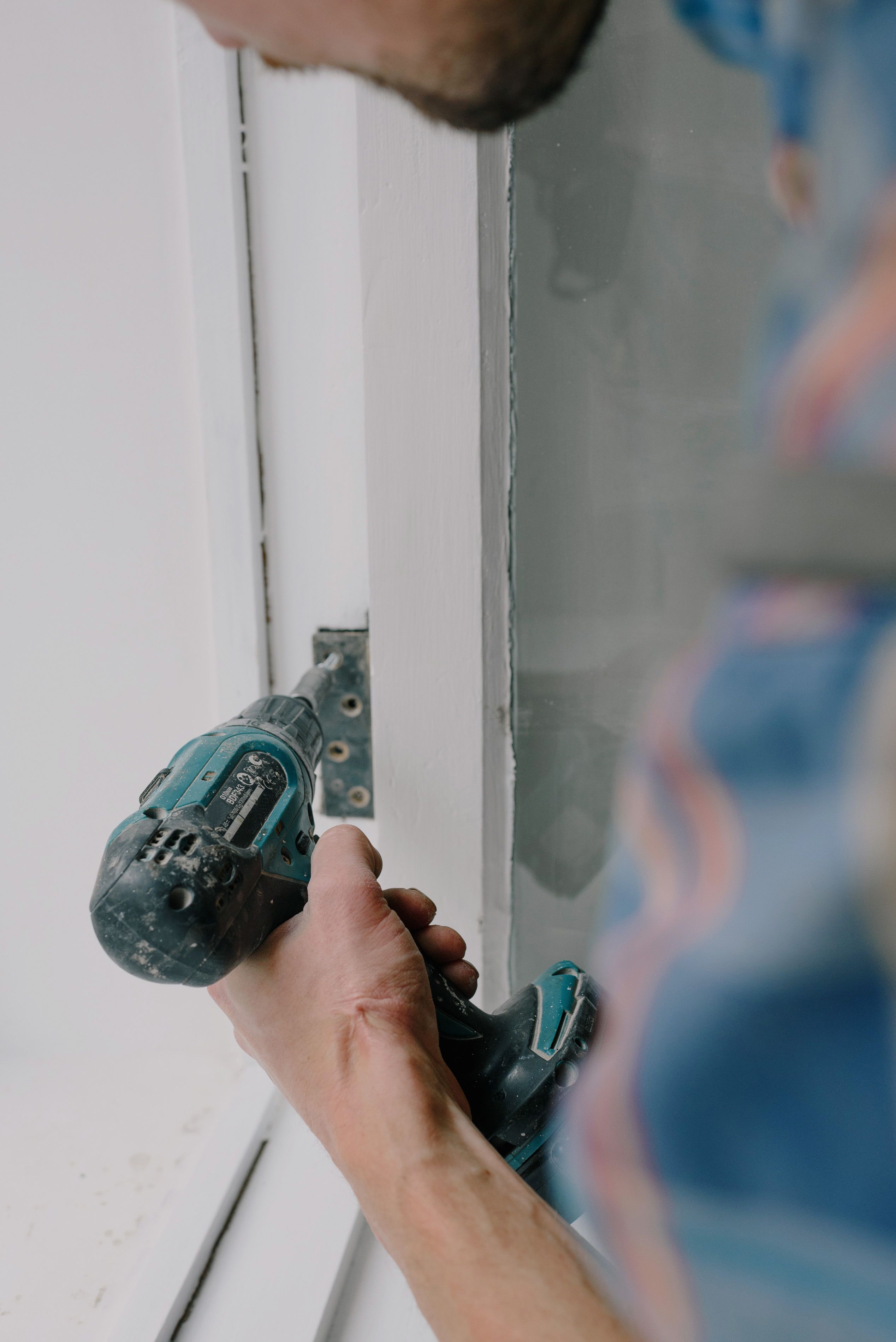 Professional hinge installation on a door frame