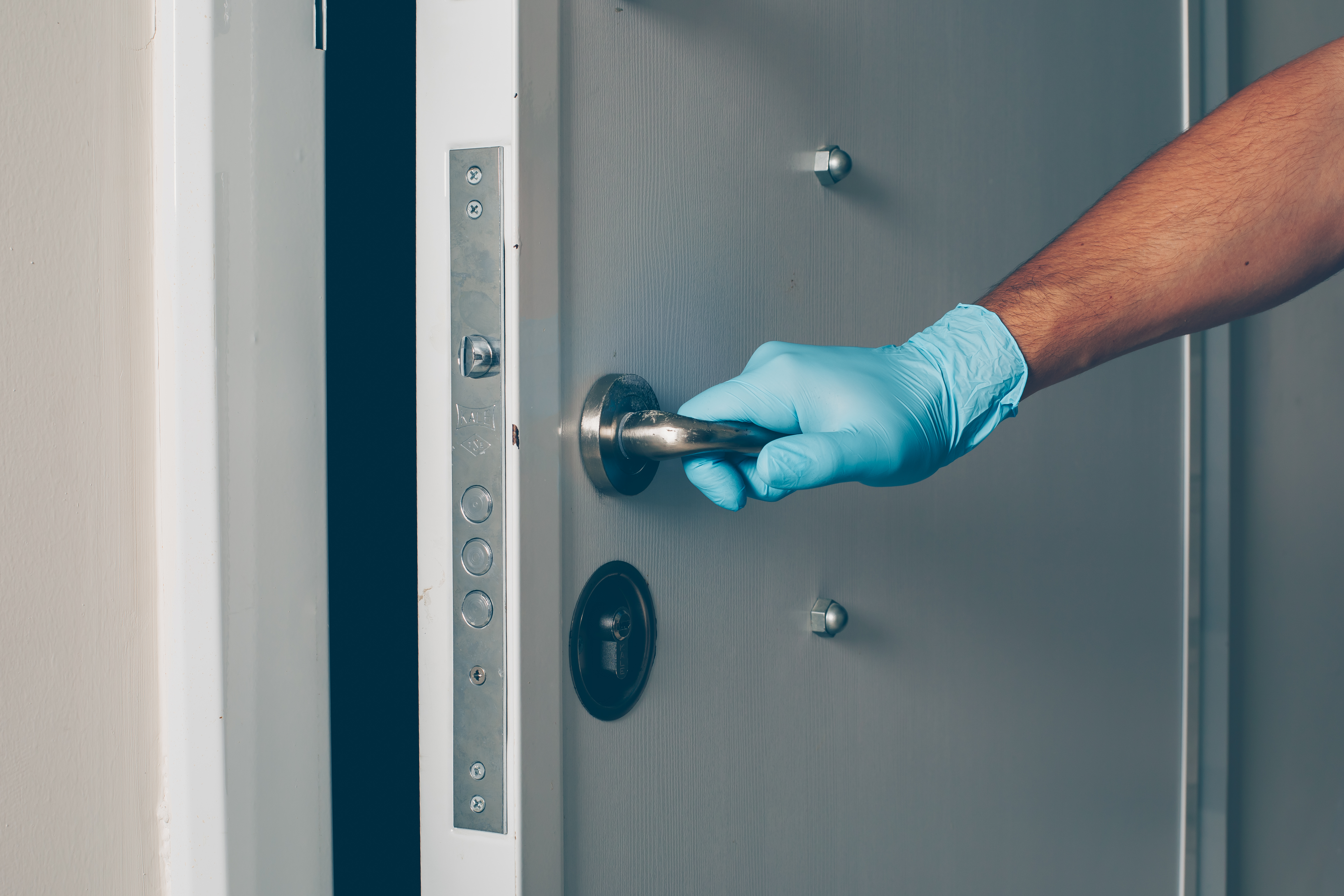 Professional JJ&D installer working on a door